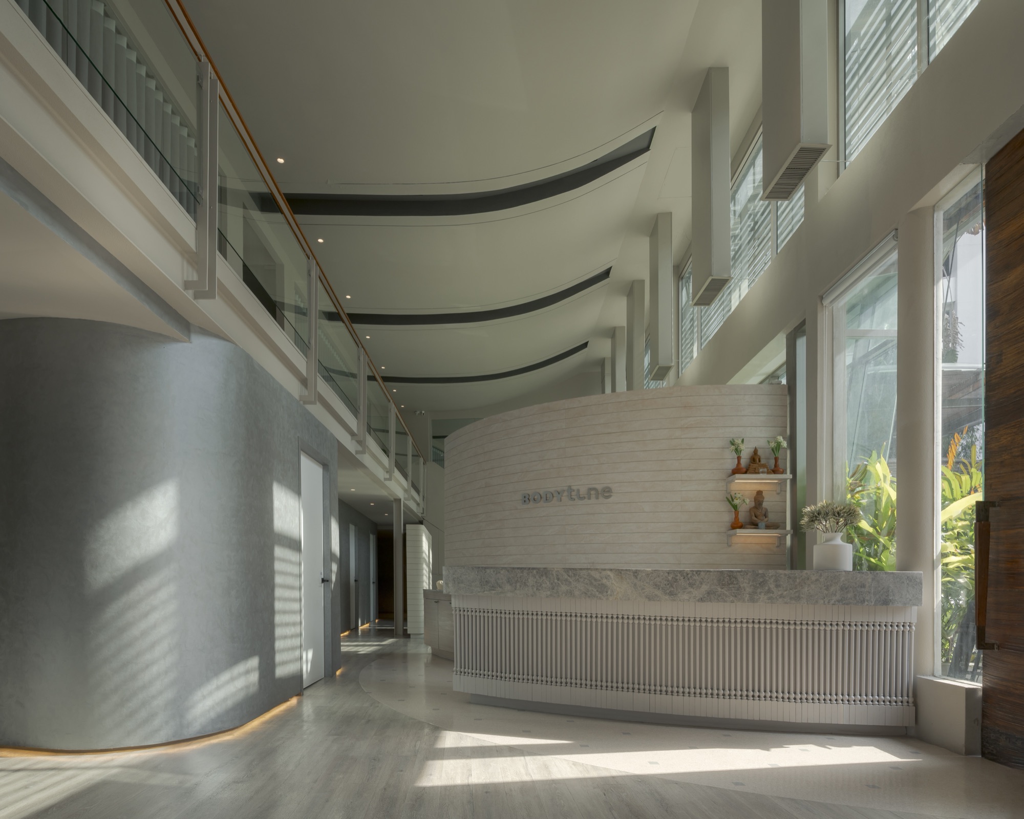 Daylight entering the curved reception atrium at Bodytune Wellness on Sukhumvit Soi 16